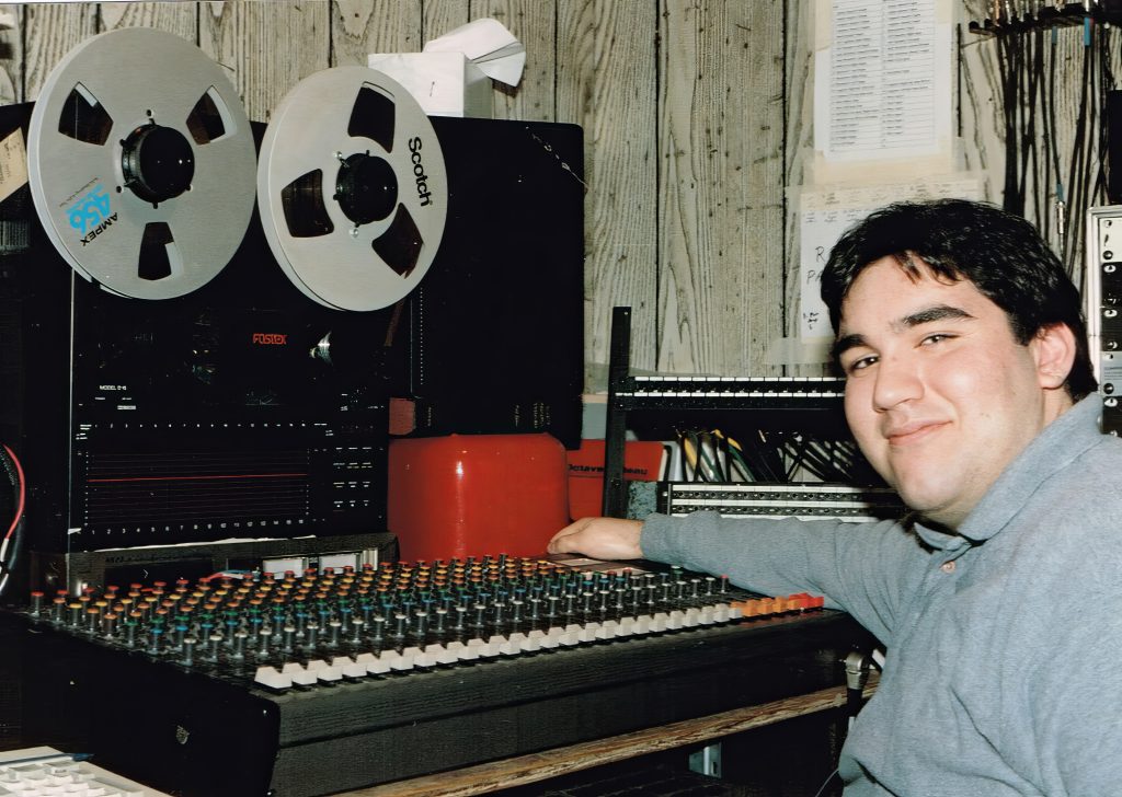 This is me around 1997 with the analog 16 track and 24 channel mixer. - Photo by Steve La Cerra